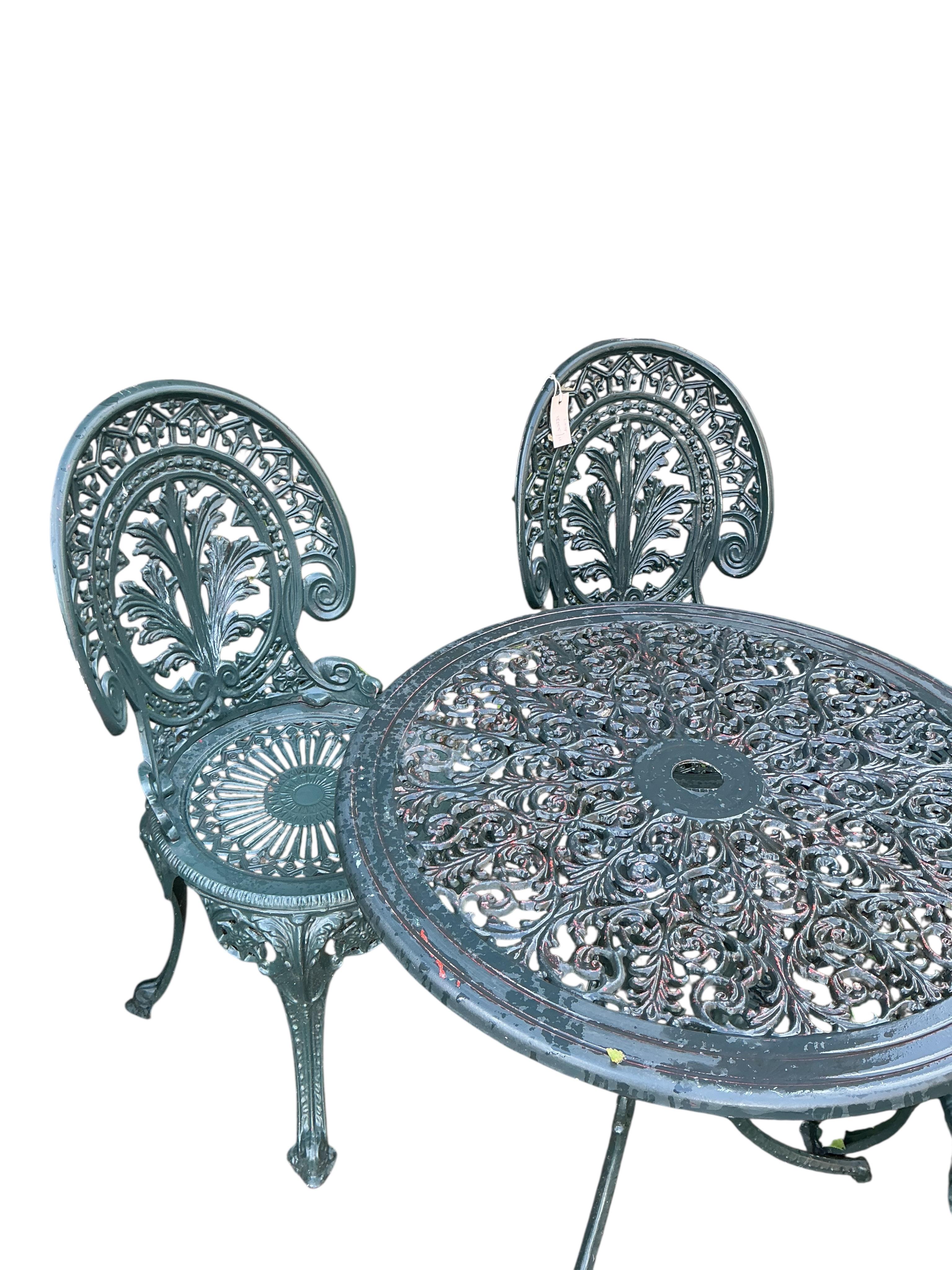 A Victorian style circular painted aluminium garden table, diameter 68cm, height 64cm together with four chairs